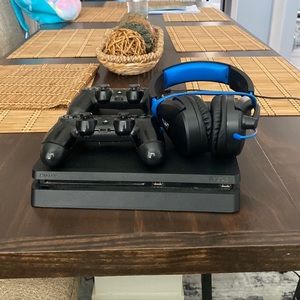 I am selling a PlayStation 4 slim with two controller & a headset.
